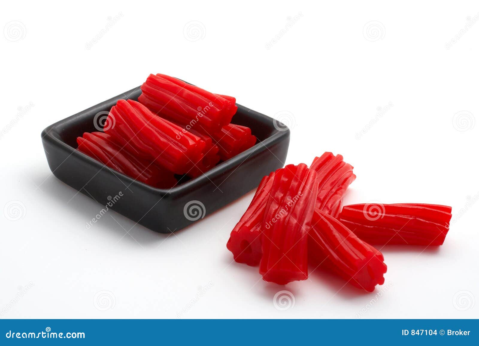 pieces of red licorice on black bowl