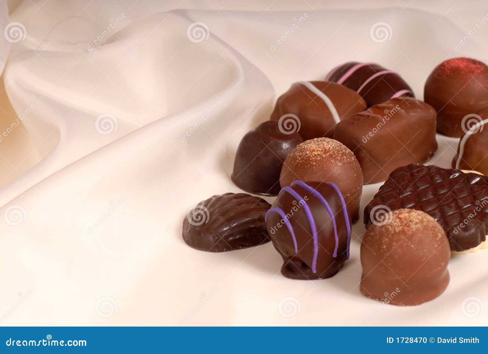 Pieces of Semisweet and Bittersweet Chocolate on Beige Satin Stock