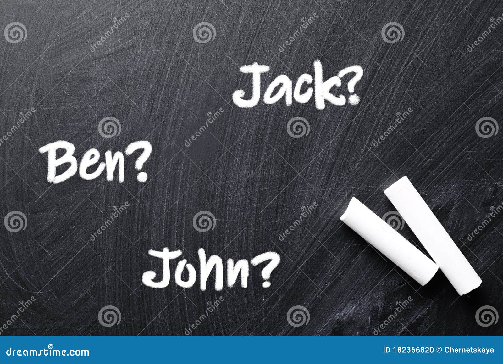 Pieces of White Chalk and Different Baby Names Written on Blackboard