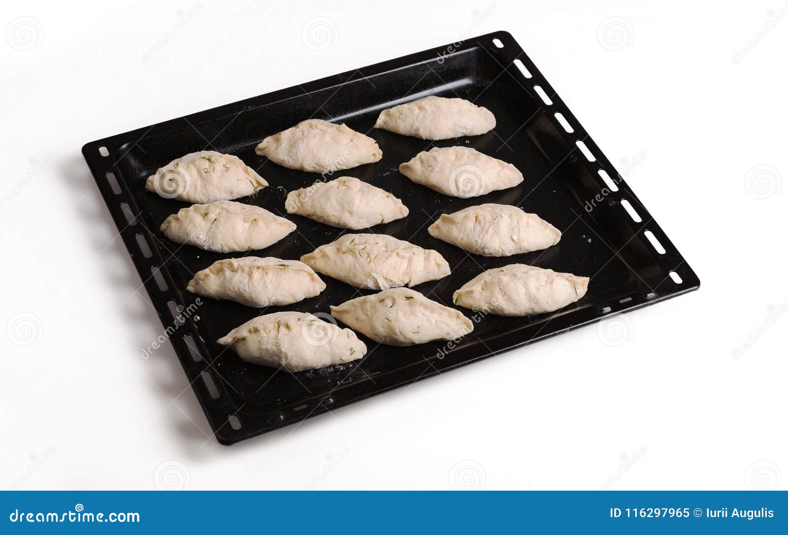 Pies Ready for Baking Lying on a Black Steel Baking Sheet. Three