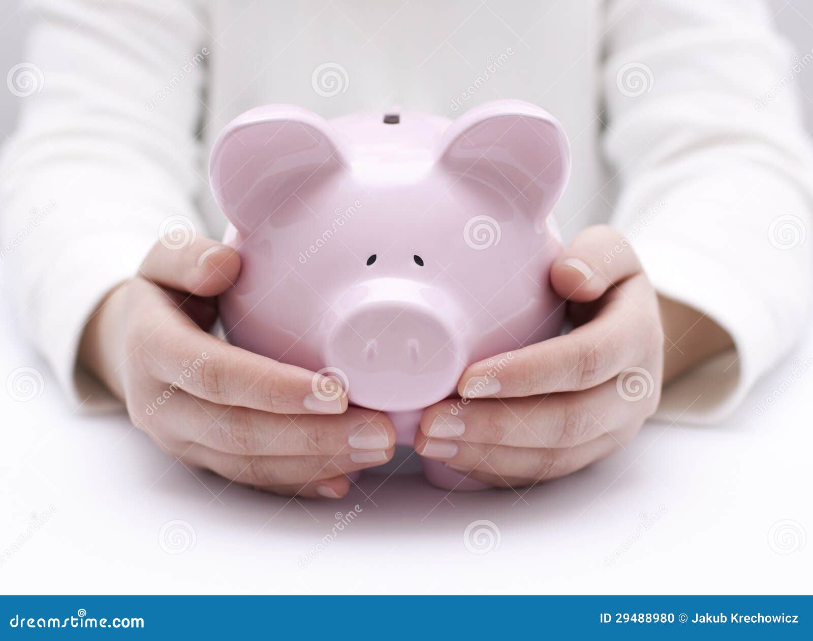 piggy bank protected by hands