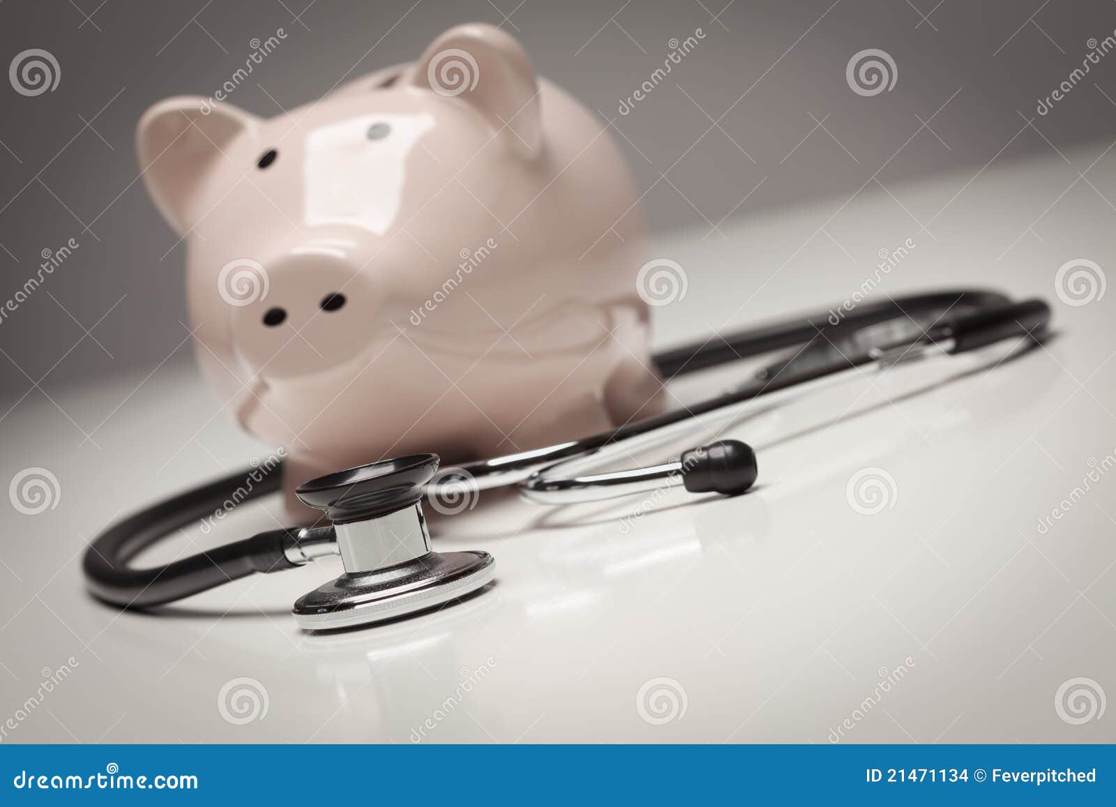 piggy bank and stethoscope with selective focus