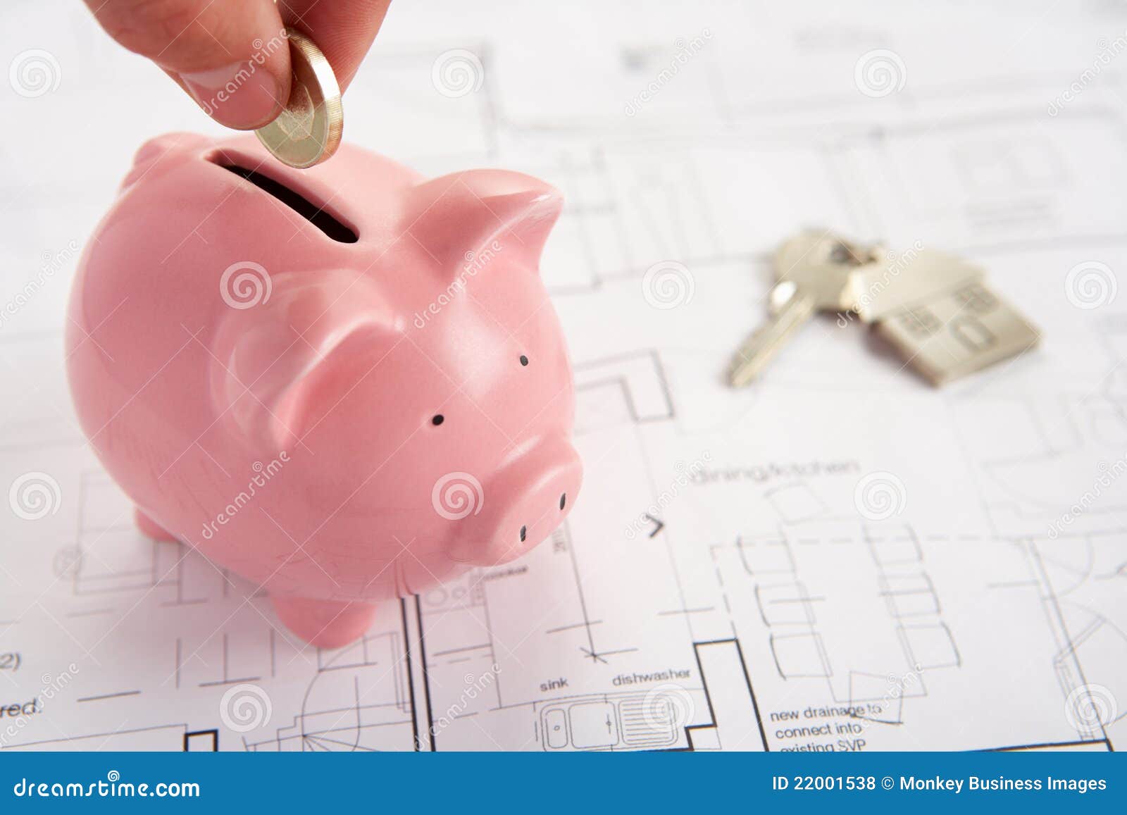piggybank with house plans and keys