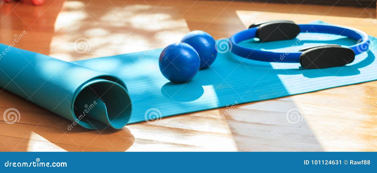 Yoga Mat And Exercise Weights On Wooden 