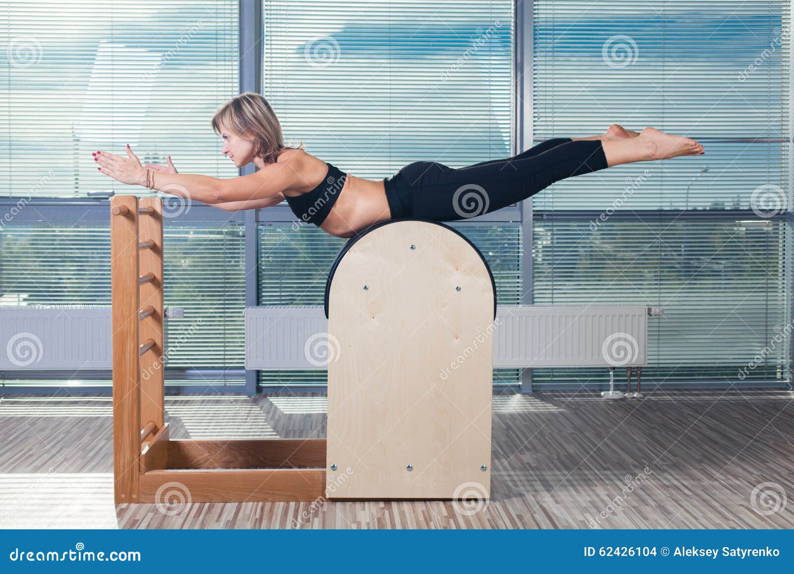 Pilates trainer exercises on a pilates barrel. Body training, perfect body  shape and posture correction opporno motor apparatus. Copy space Stock  Photo - Alamy