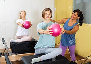 Pilates Instructor Shows Boy How To Exercise With Ball Stock Photo 