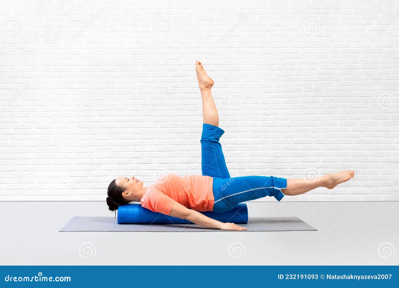 Pilates with Props. Adult Woman Lying on Back and Practice Scissors  Exercise Using a Foam Roller in Fitness Studio Stock Image - Image of  health, instructor: 232191093