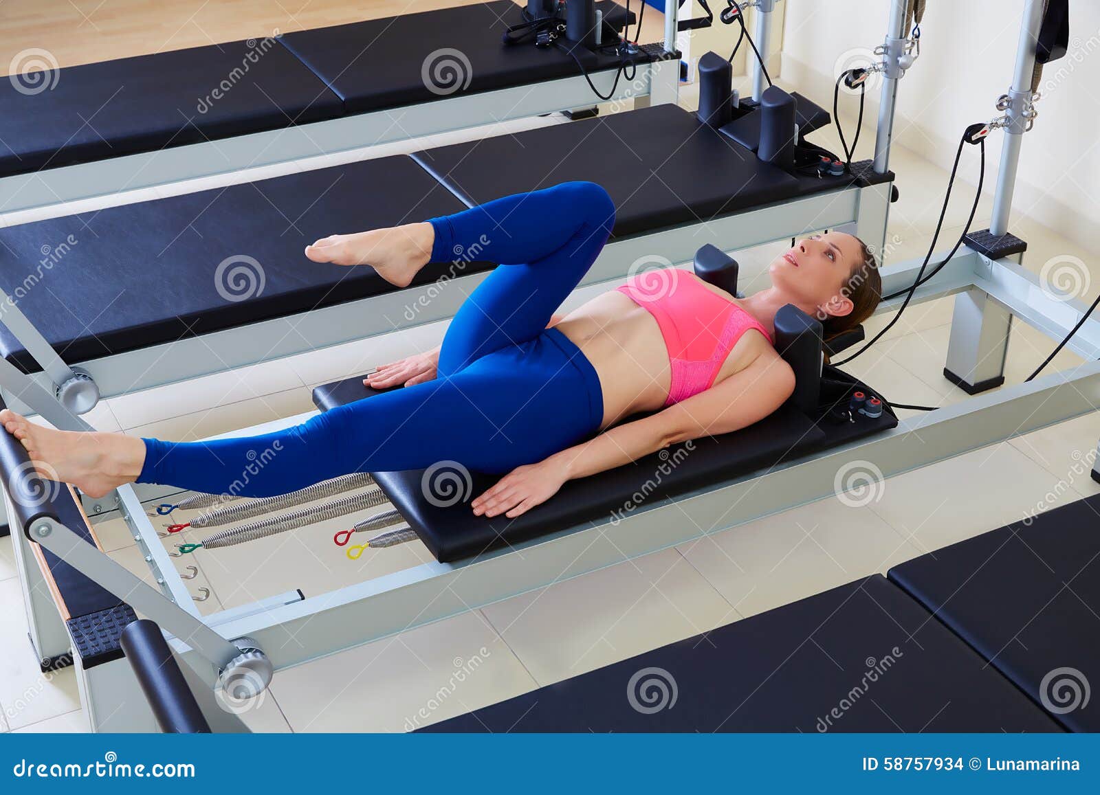 pilates reformer woman foot work exercise