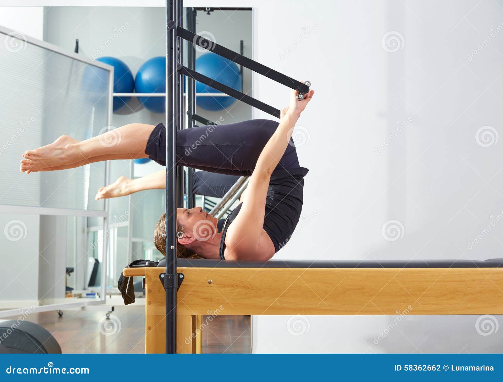 pilates woman in reformer roll over exercise