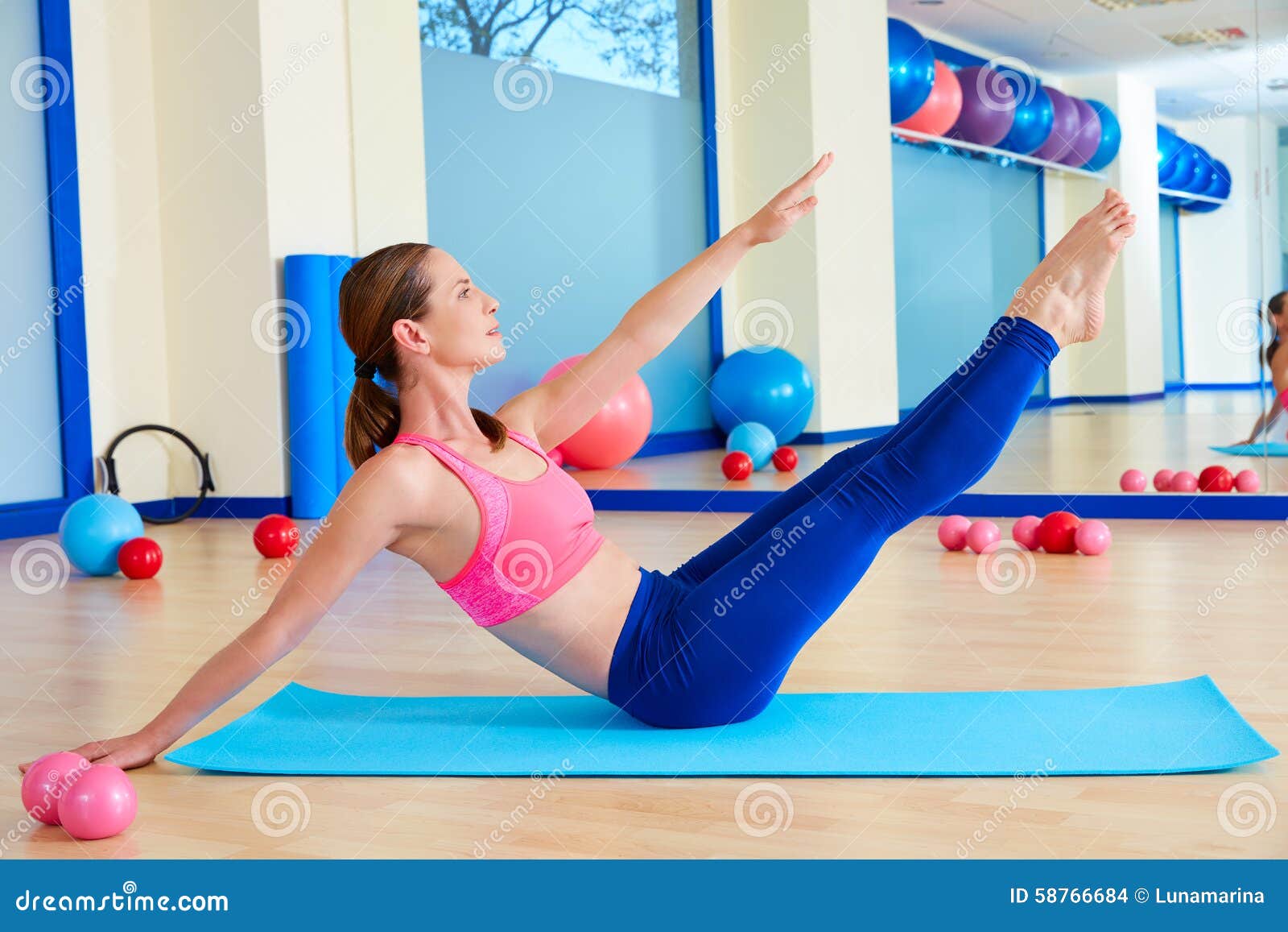 pilates woman teaser exercise workout at gym