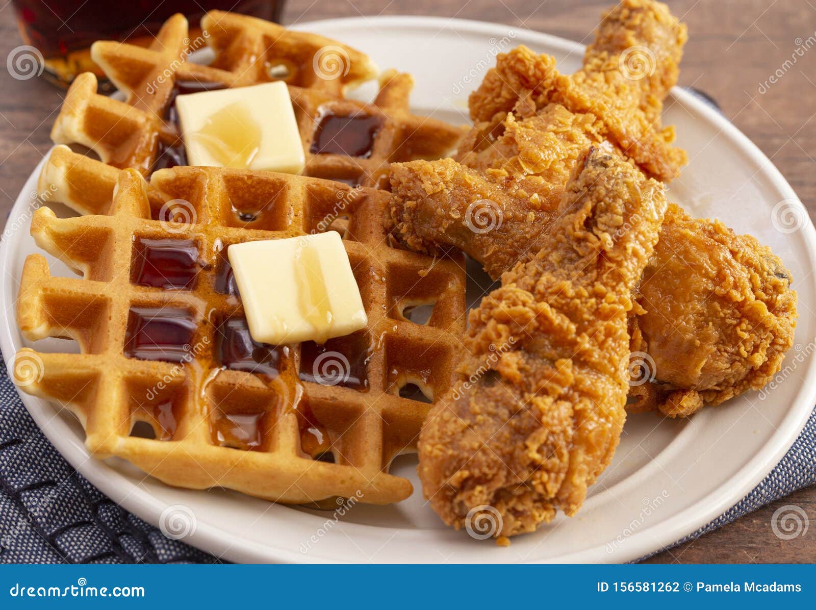 Pile of Chicken and Waffles on a Rustic Wooden Counter Stock Photo