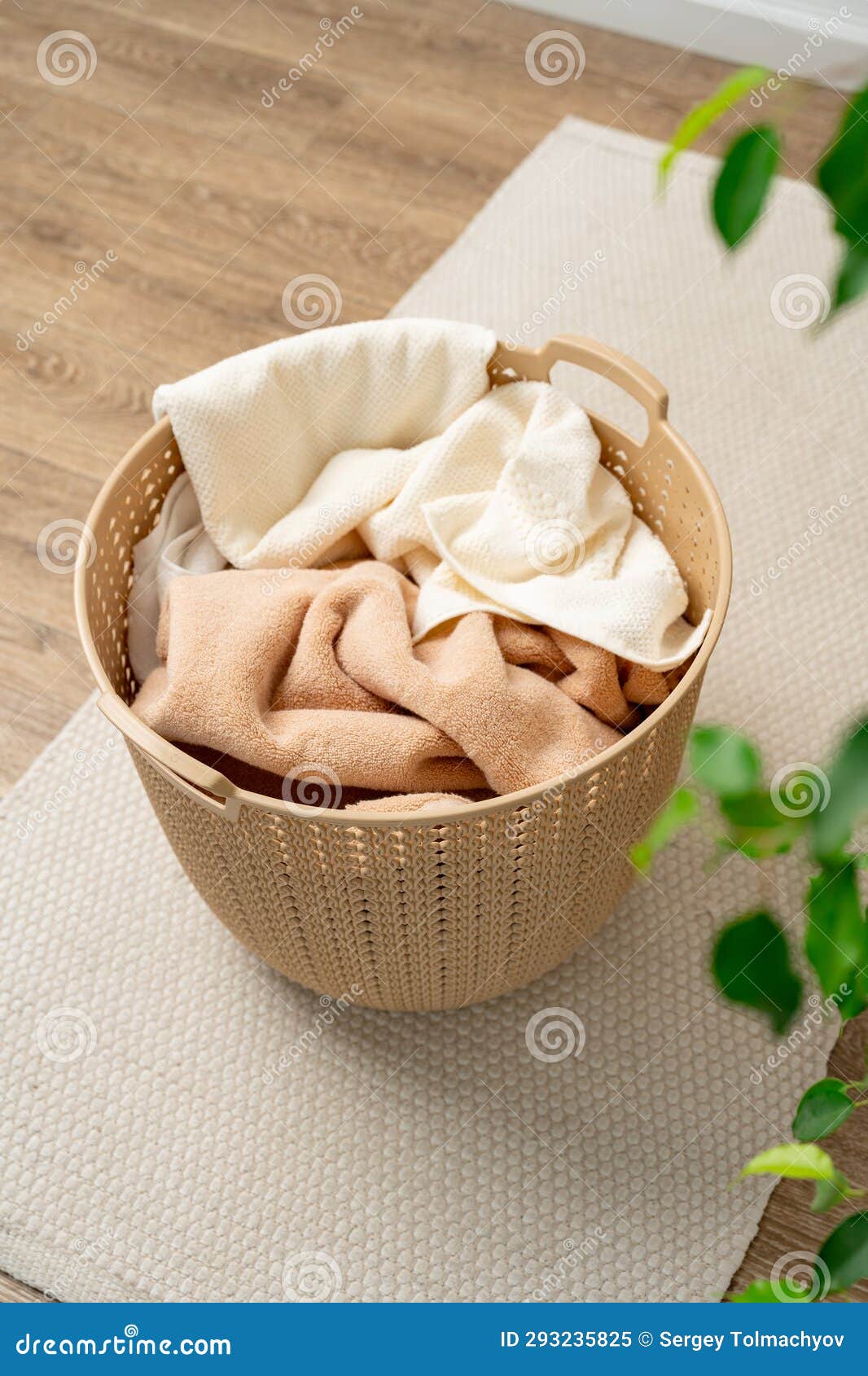 Pile of Clothes in Plastic Laundry Basket in the Bathroom Stock Image
