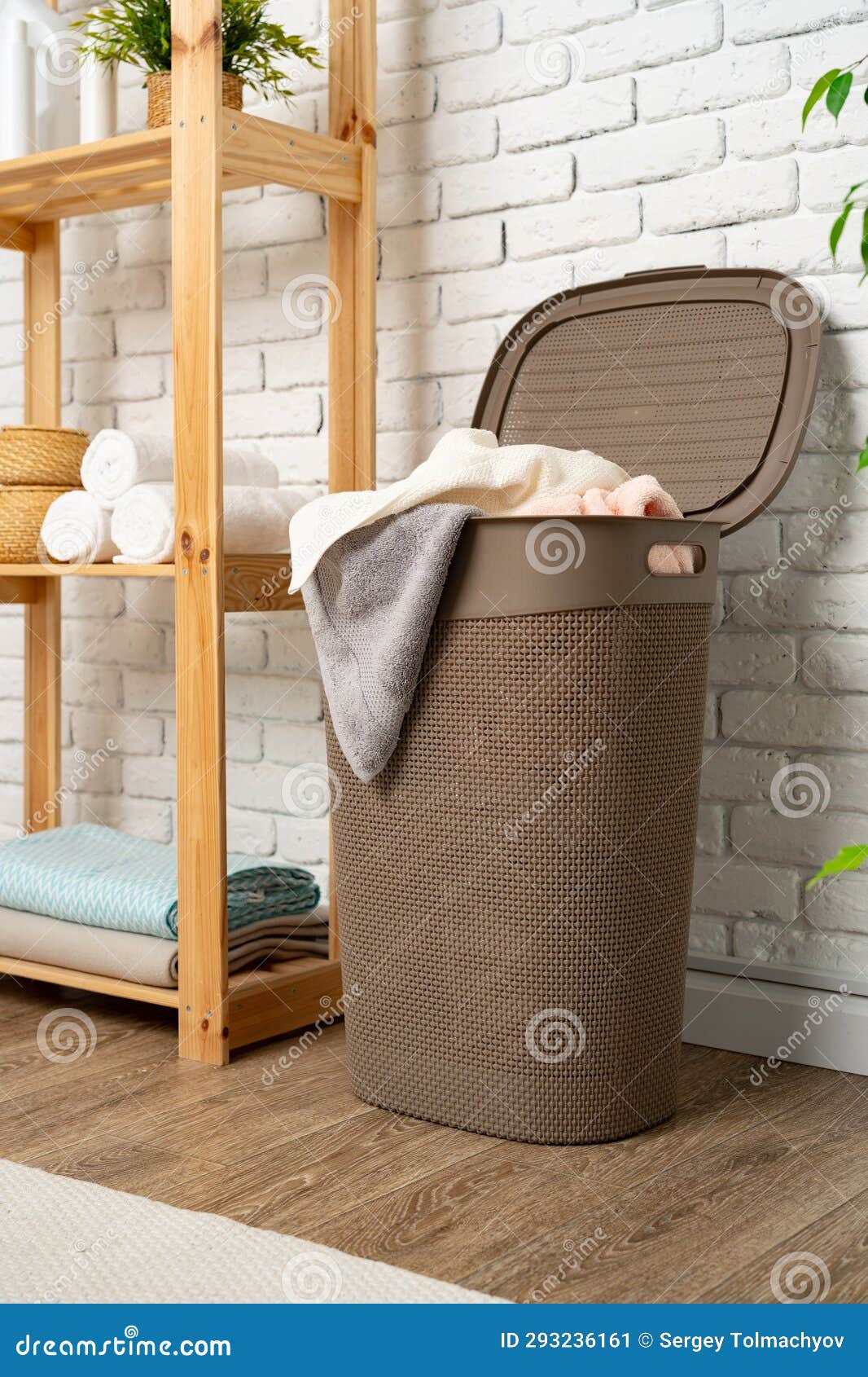 Pile of Clothes in Plastic Laundry Basket in the Bathroom Stock Image