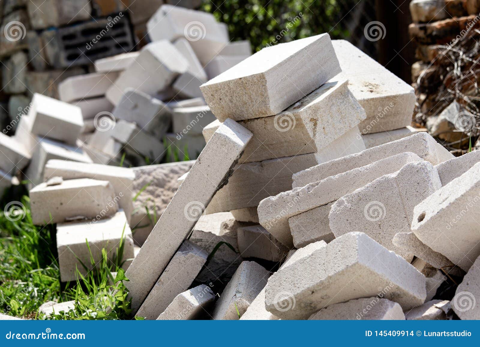 A Pile of Construction Waste is in the Yard. White Brick or Foam Block