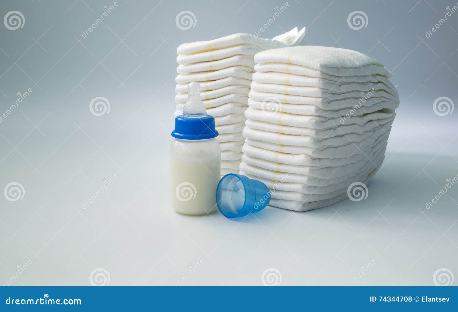 Pile Of Diapers And Baby Bottles On White Background Stock Photo ...