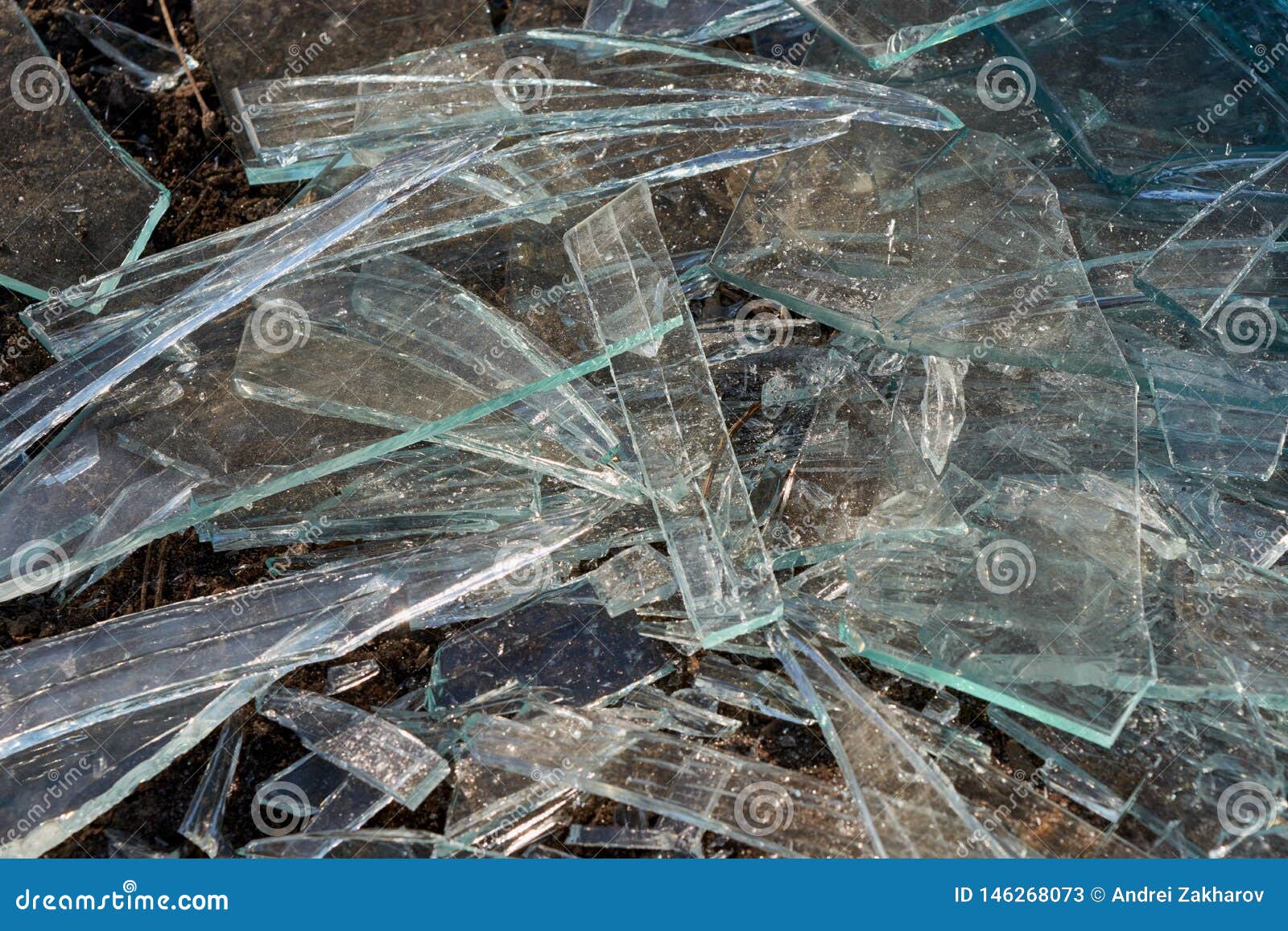 A Pile of Different Sharp Pieces of Broken Glass Lying on the Ground