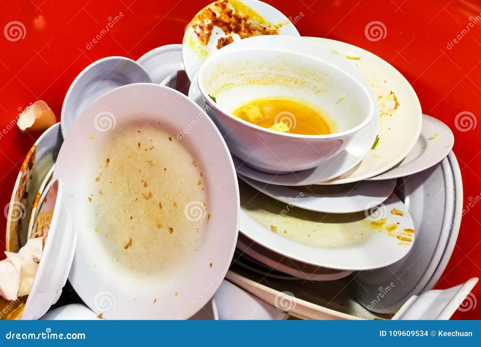 Pile of Dirty Oily Messy Used Plates, Bowls, Cups, Saucer. Stock Photo