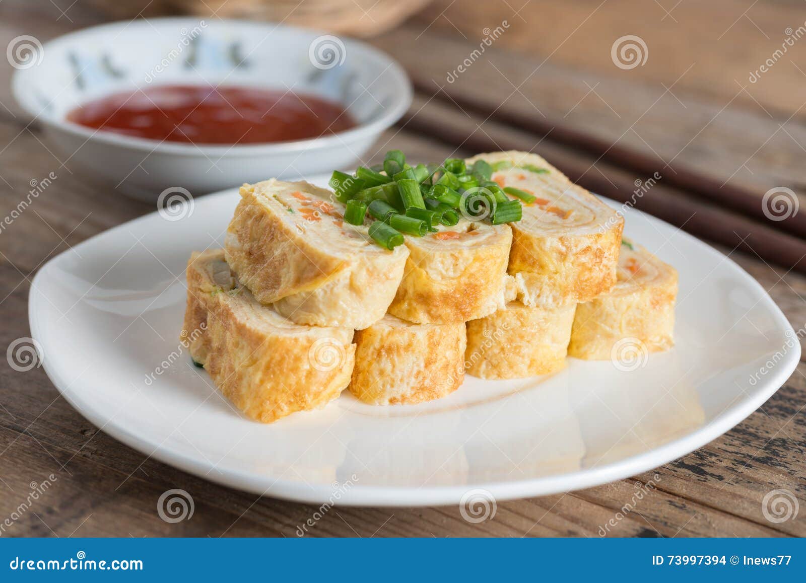 Pile of Eggs Roll with Carrot and Onion on White Plate. Stock Photo