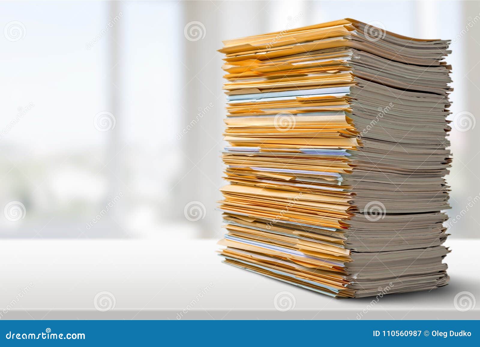 pile of files in folders on light background