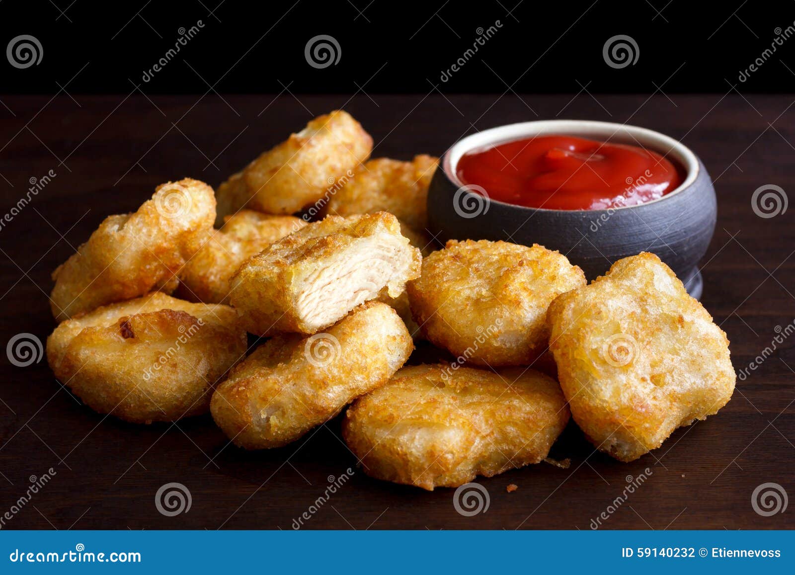 pile of golden deep-fried battered chicken nuggets with empty ru