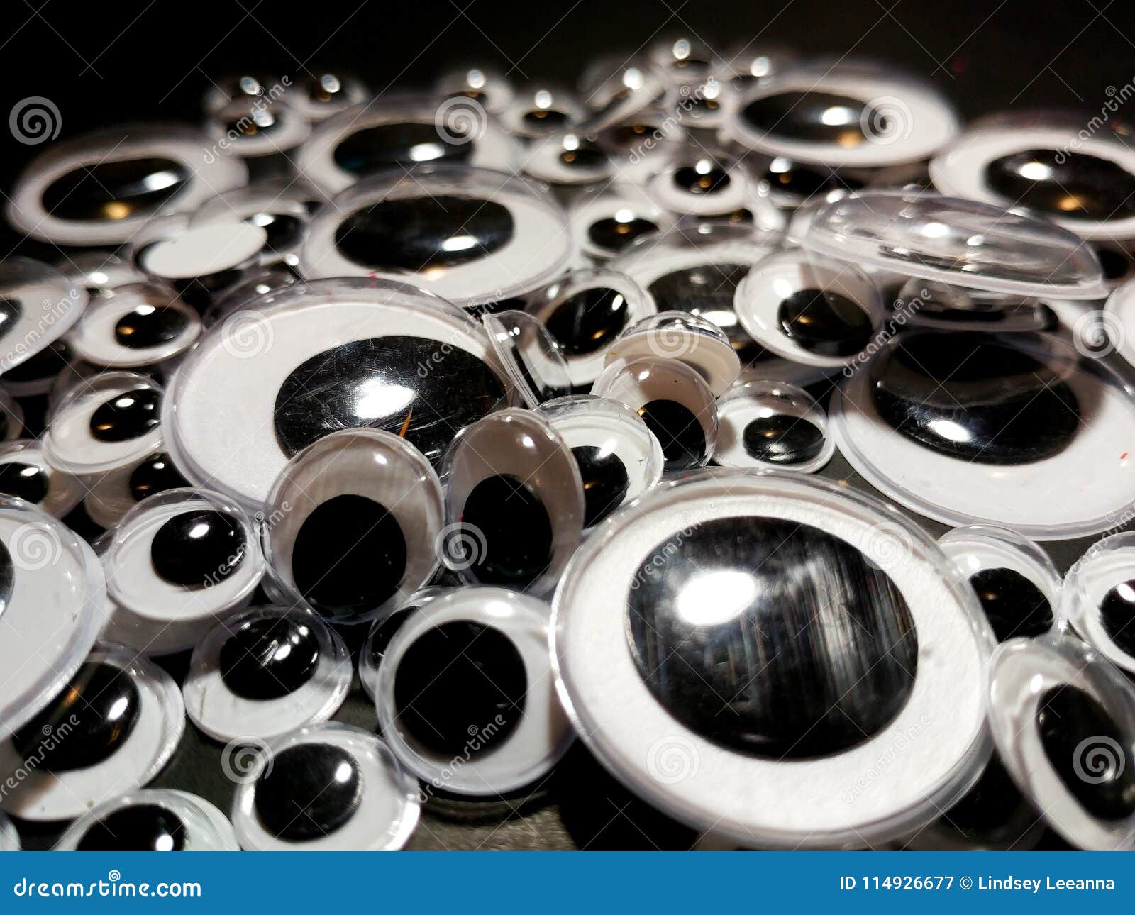 Googly eyes are small plastic craft supplies used to imitate eyeballs  isolated on white background., Stock image