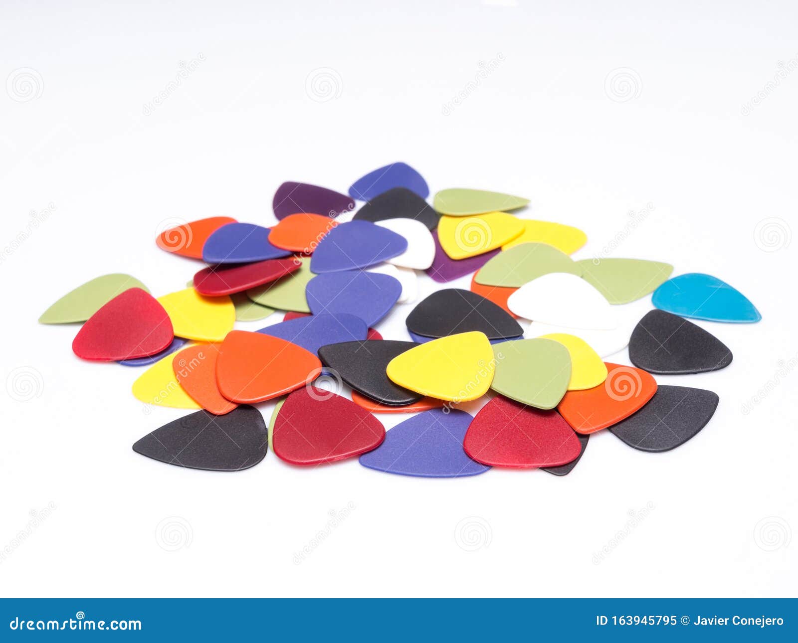 A Pile of Guitar Picks Isolated in White Background with Space for Text