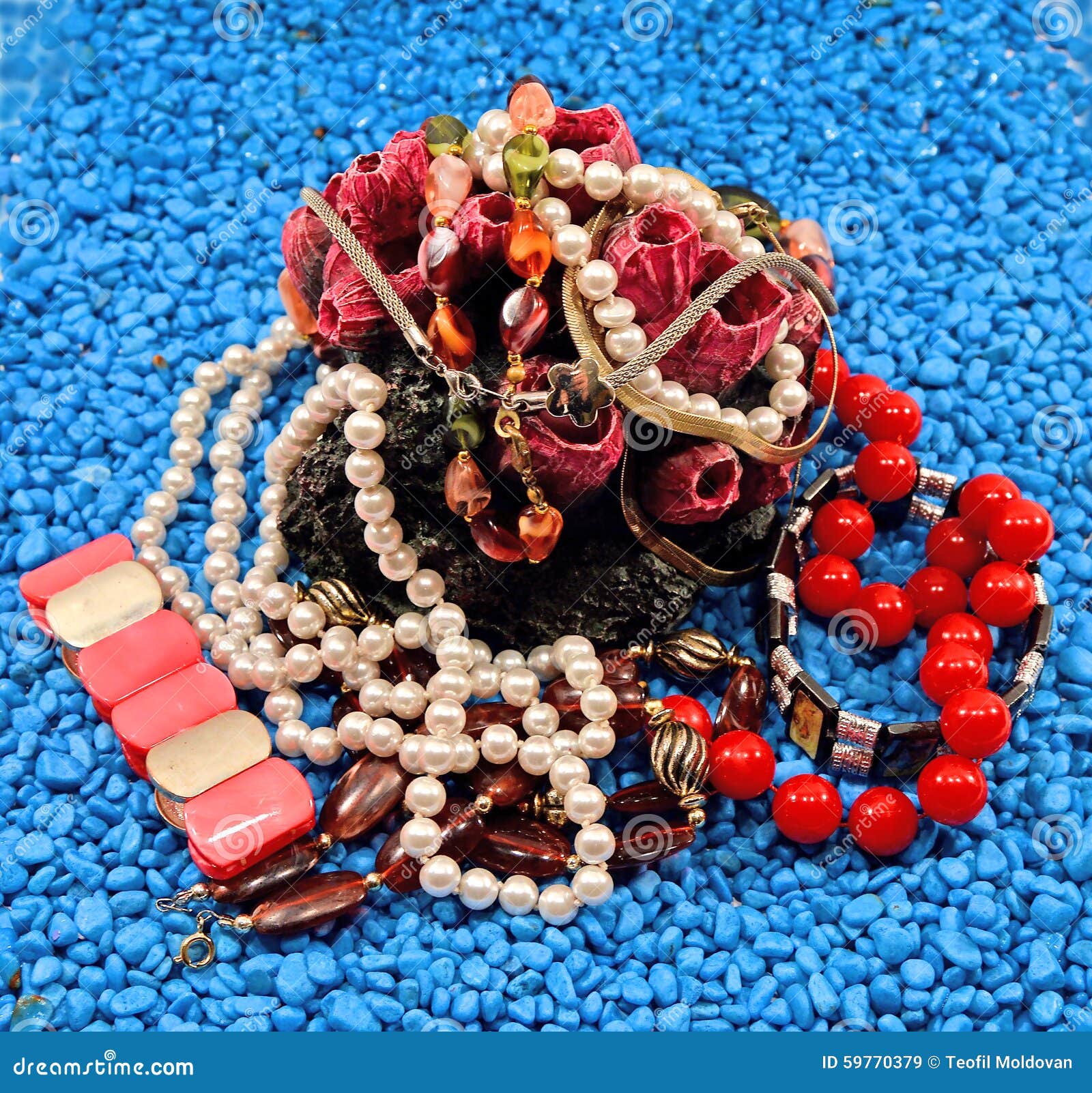 Pile of jewels. Jewelry stones placed on blue Photo taken on: July 21st, 2015