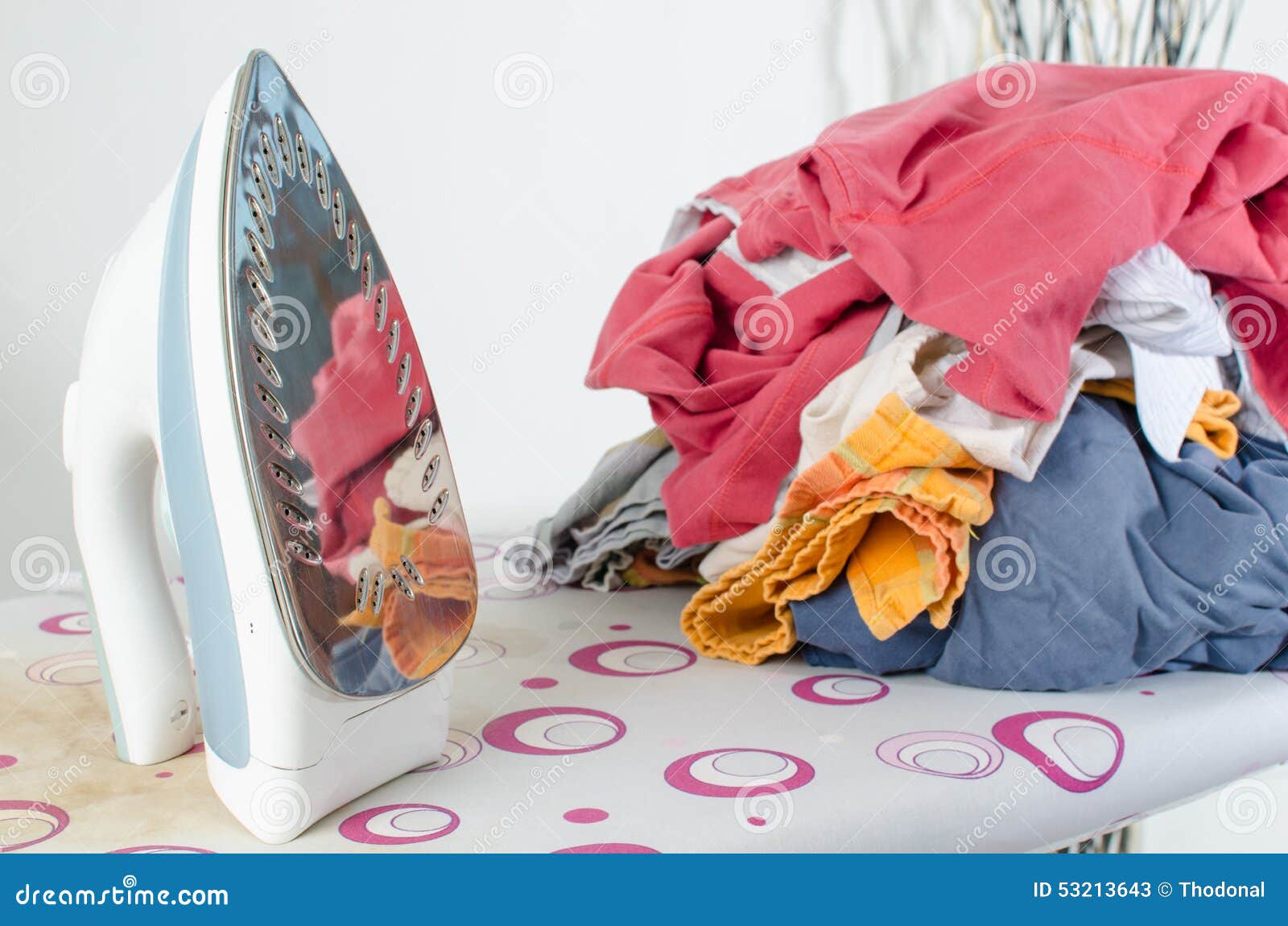 Pile of Laundry and Iron on Ironing Board Stock Image Image of