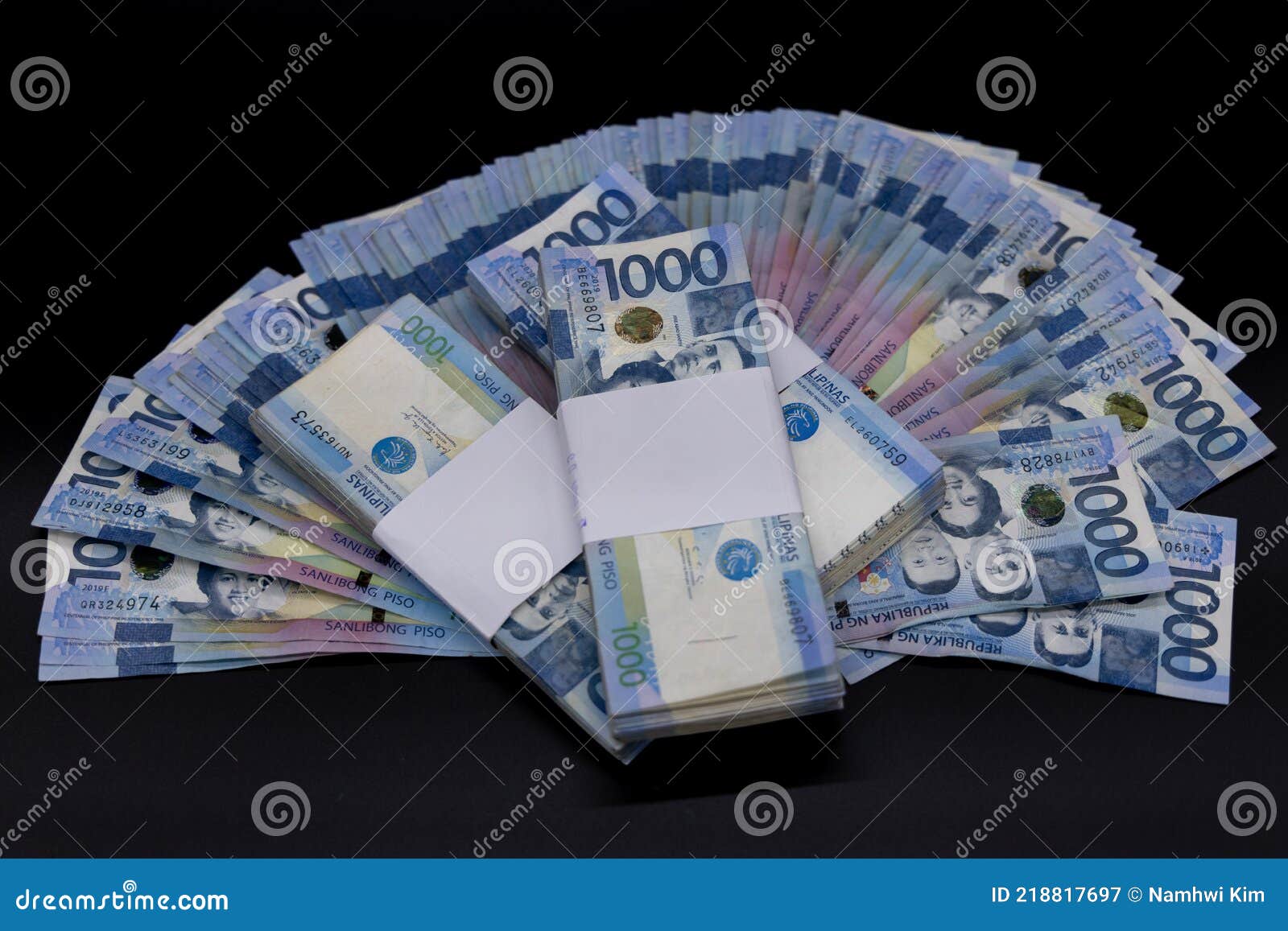 A pile of one thousand Philippines banknotes. Cash of Thousand