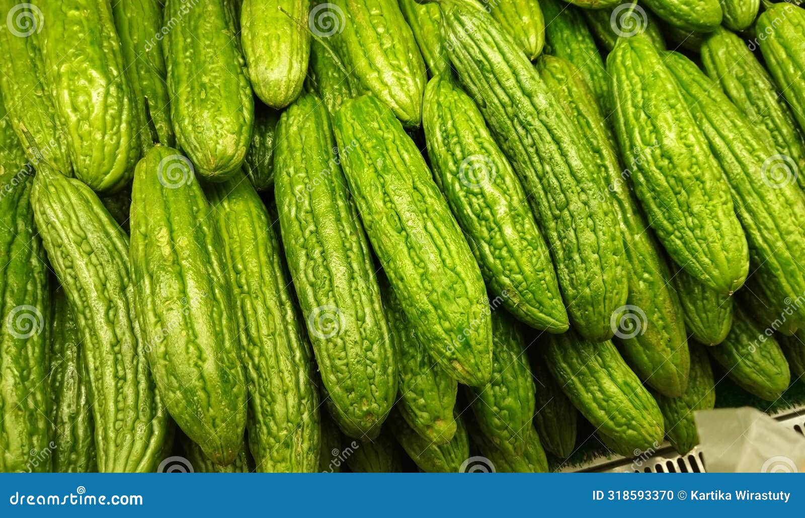 pile of pare or bitter melon or bitter squash on display at market, famous for its bitterness