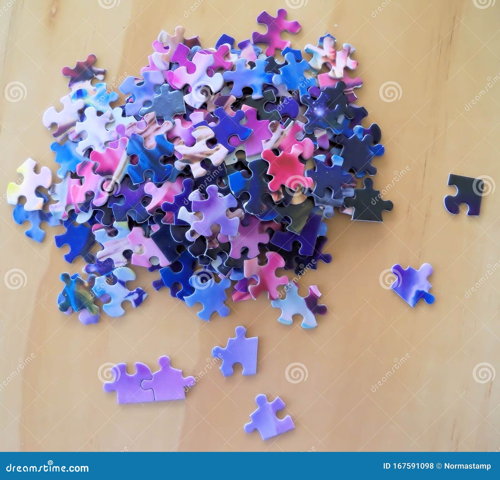 Multi Colored Puzzle Pieces on a Wooden Surface Stock Illustration