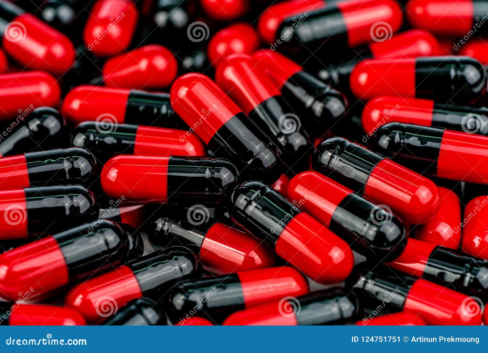 pile of red-black capsule pills. antibiotics resistance. drug use with reasonable. global healthcare concept. antibiotics drug