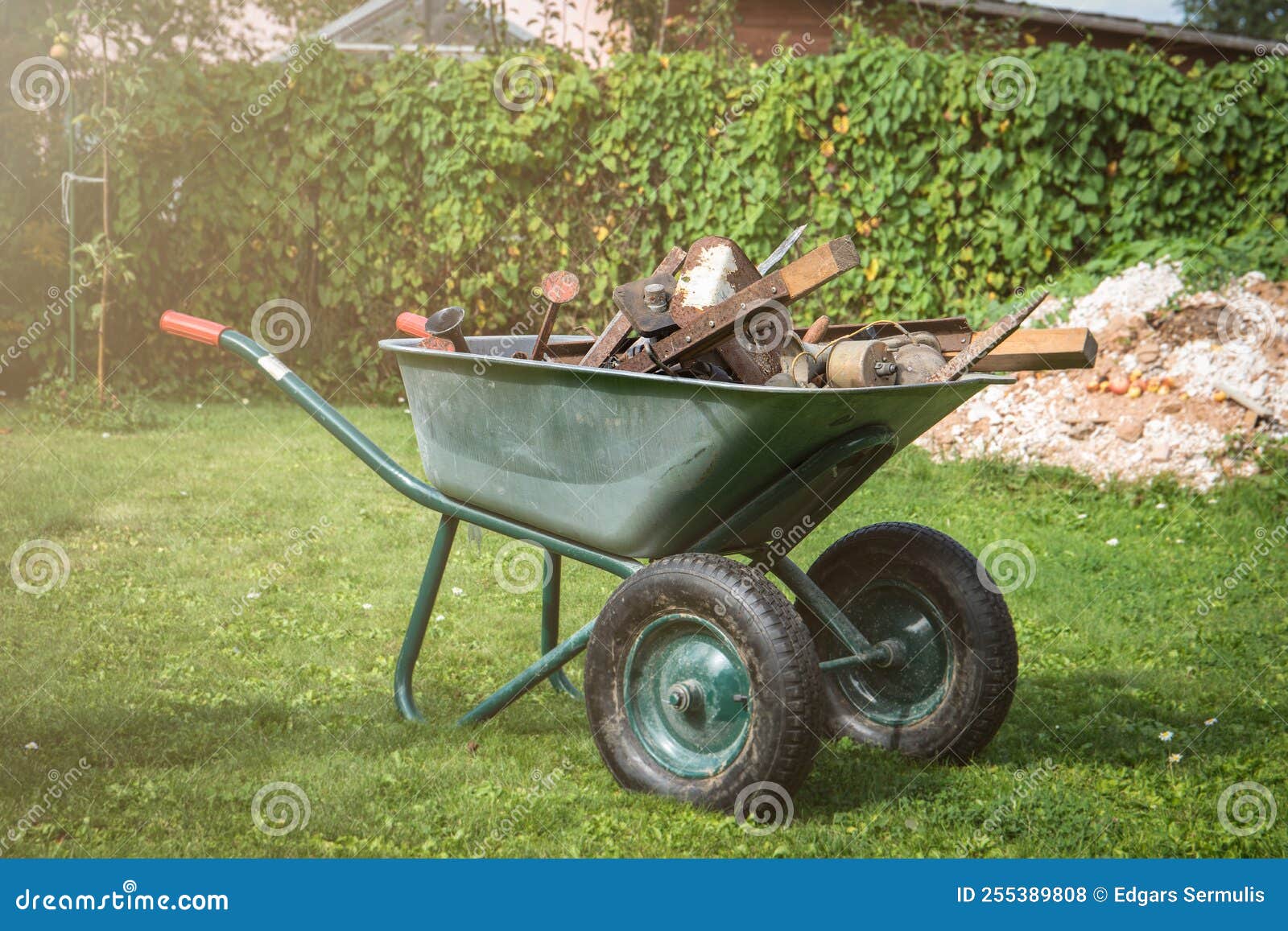 pile of scrap metal in a barrow. yard and garden cleaning