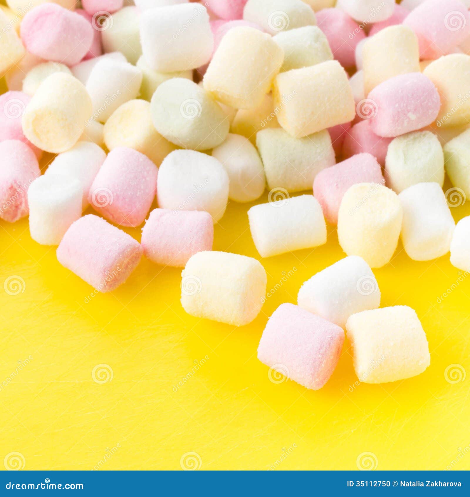 A Pile Of Small Colored Puffy Marshmallows On Bright Yellow Ba Stock