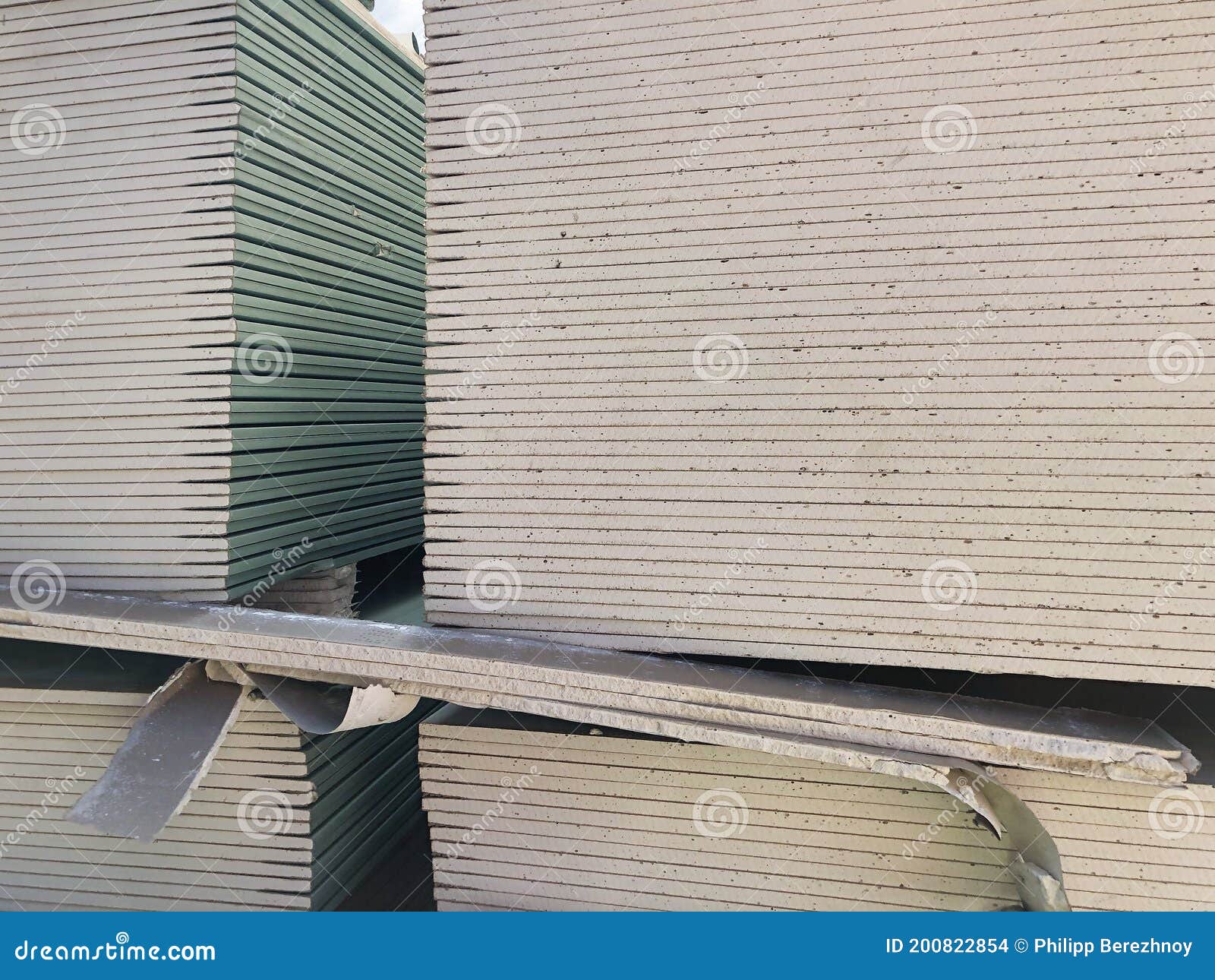 Piled Sheets of Drywall. Stacked Plasterboard Sheets. Gypsum Cardboard