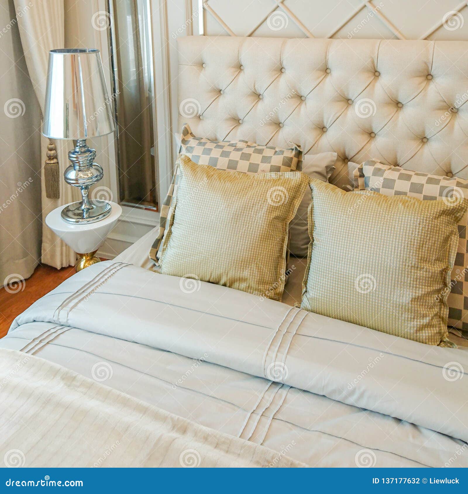 Pillows on bed and lamp stock photo. Image of style 137177632