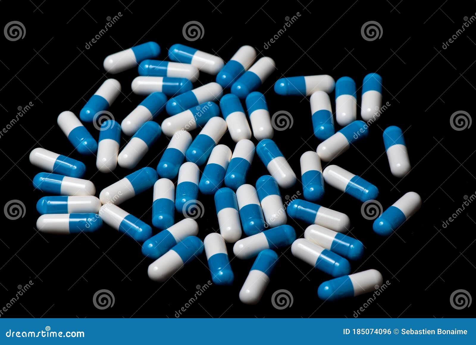 pillules de mÃÂ©dicaments blanche et bleu sur un fond noir