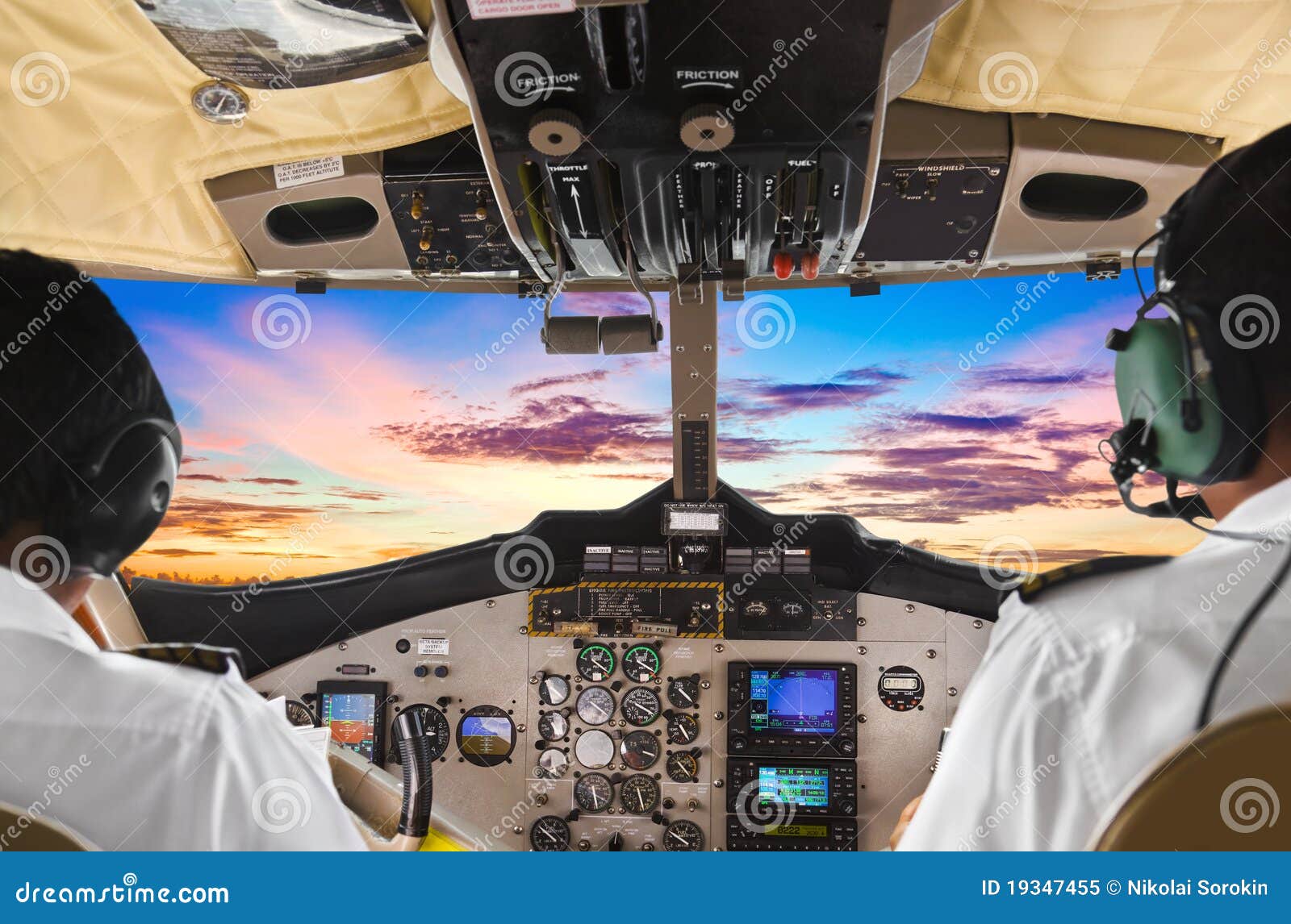 pilots in the plane cockpit and sunset