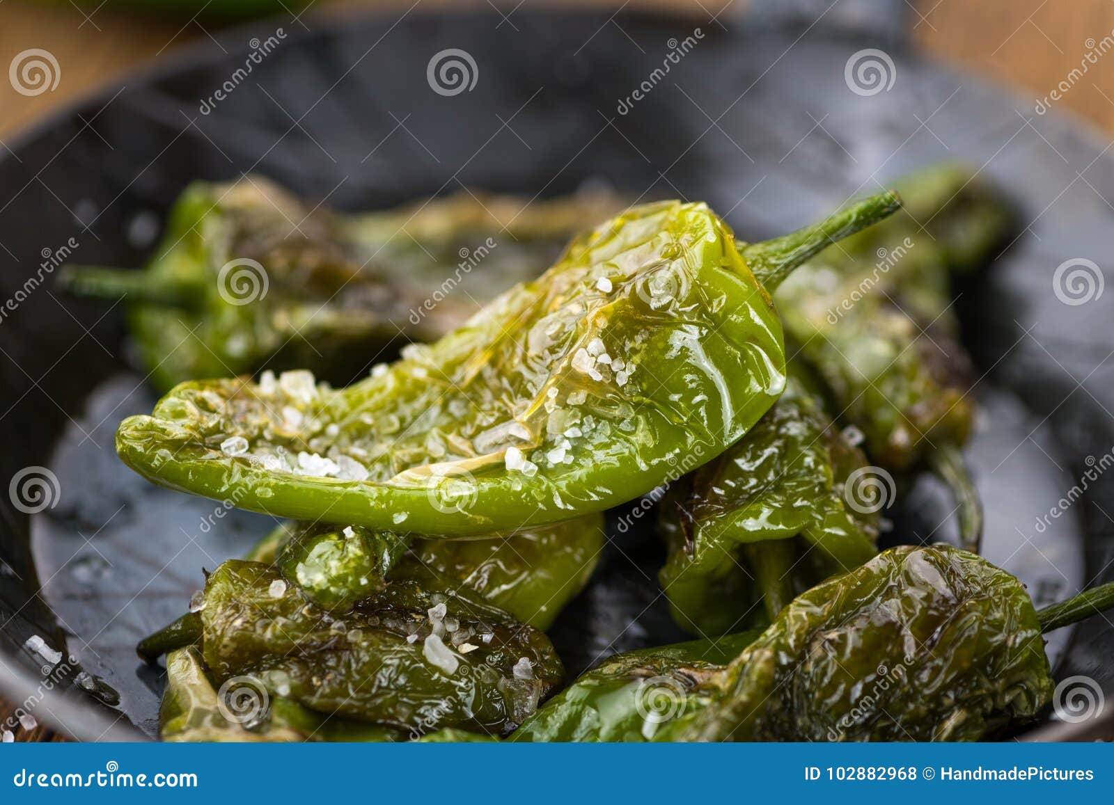 pimientos de padron on wooden background; selective focus