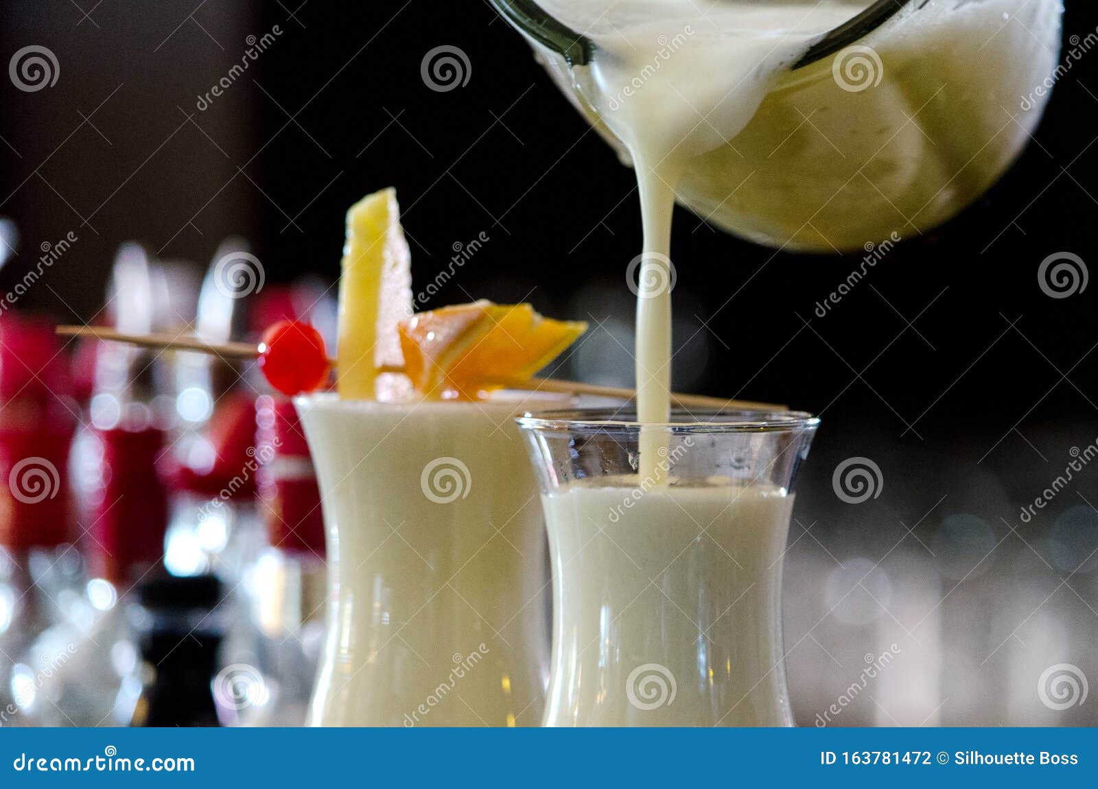 pina colada, exotic cocktail ready to serve and is poured into a glass