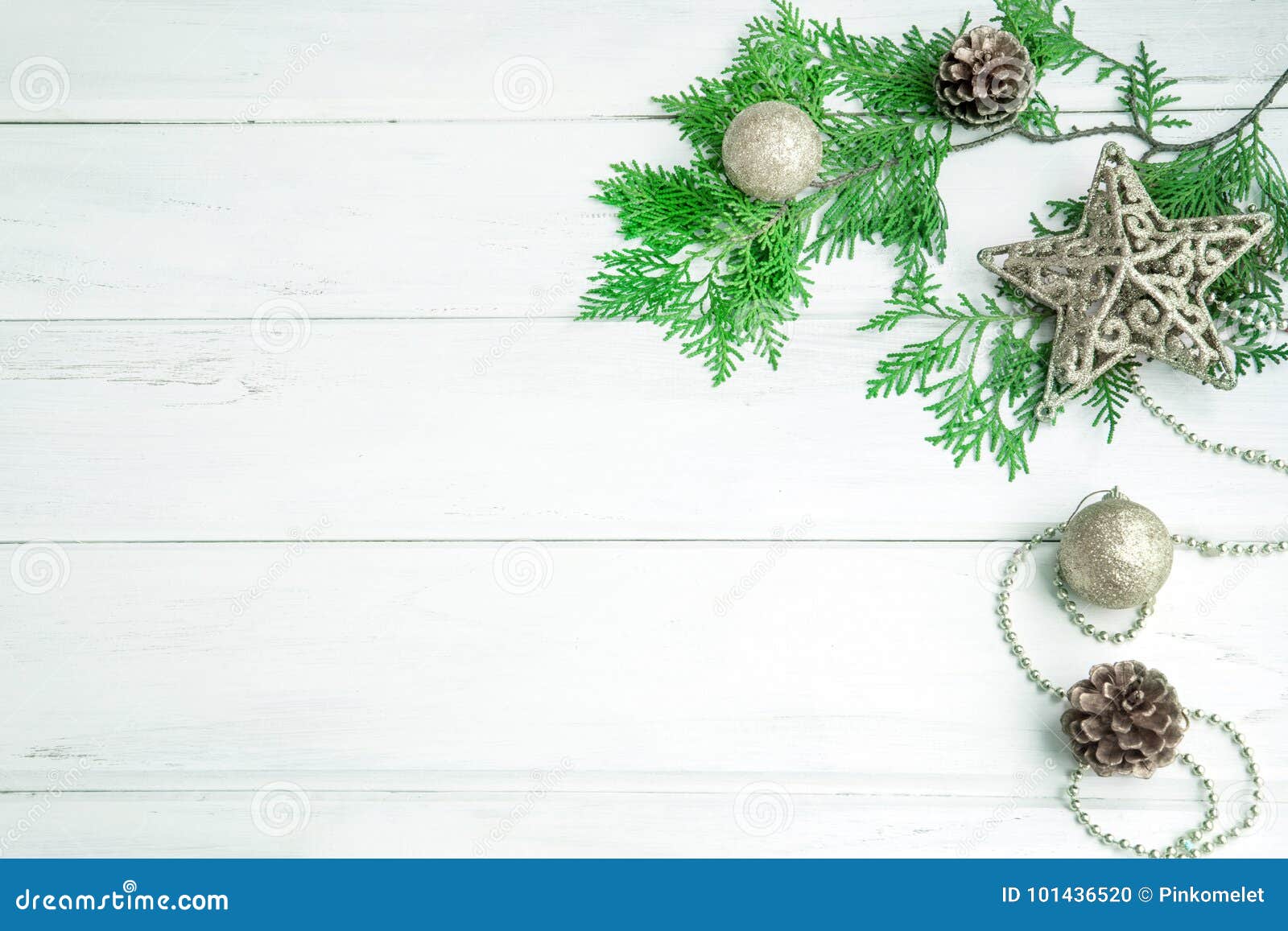 pine leaf with silver star and christmas ball decoration on white wooden board with copy space , happy new year and chistmas festi