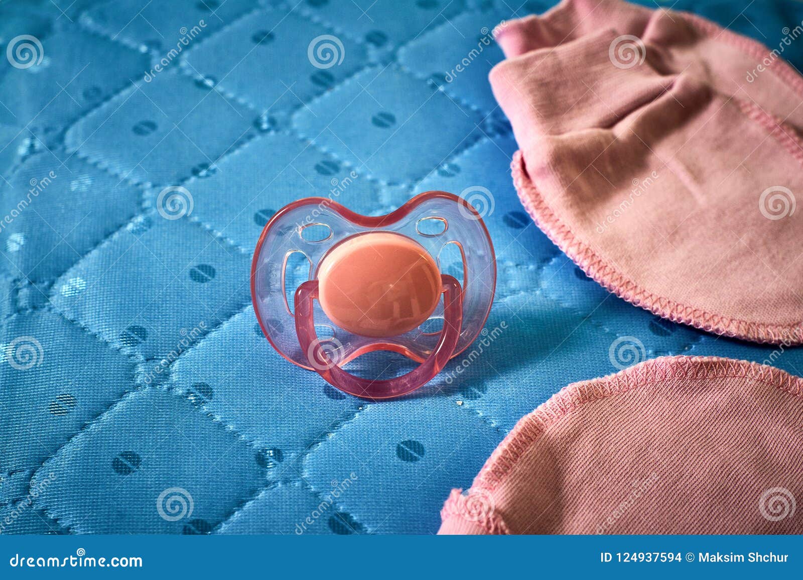 Babys Dummy, Cap and Socks in a Cot Stock Photo - Image of dummy ...