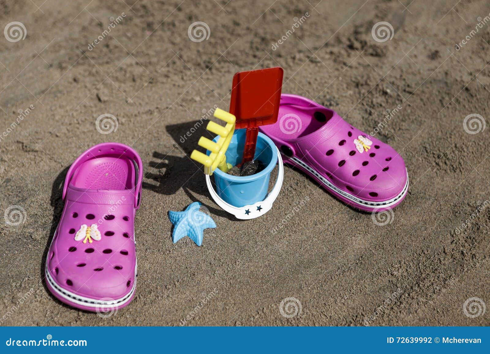 Pink Beach Crocs and Blue Sand Toys on Sandy Beach.Beach Flip Flops in ...