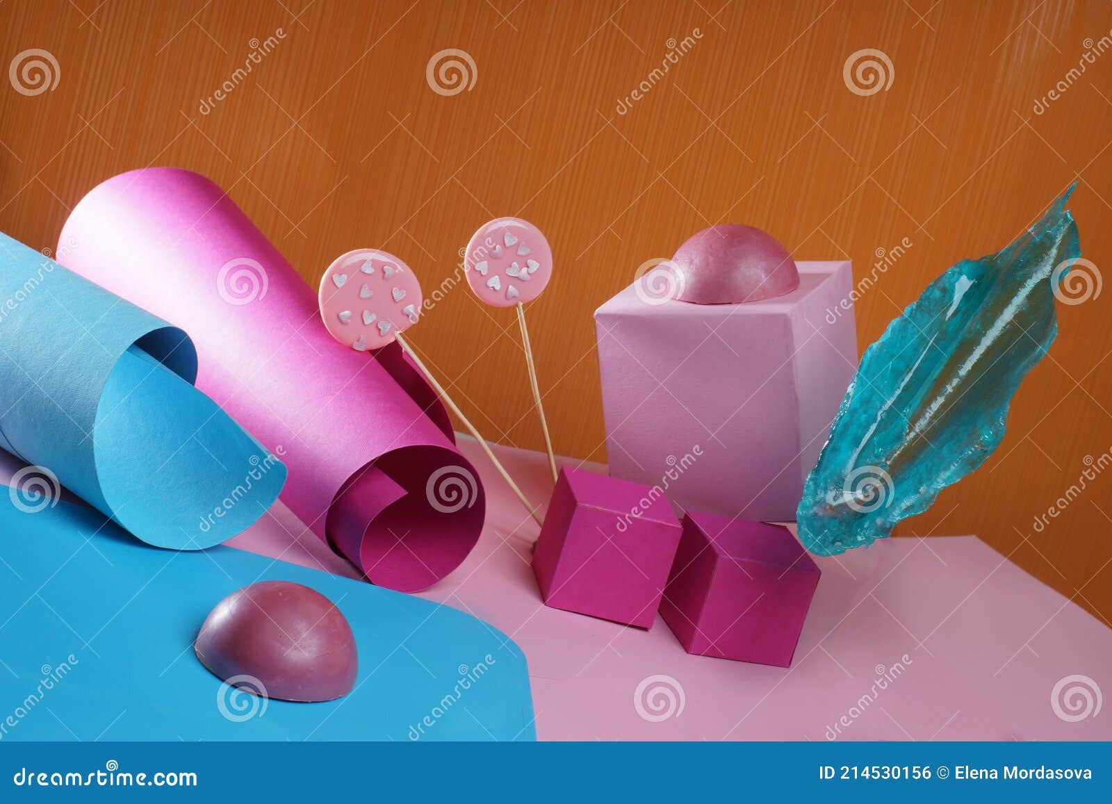 Pink And Blue Sweets On A Background Of Bright Cardboard Shapes Stock