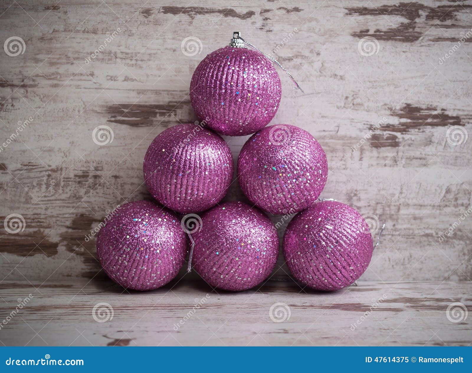 Pink Christmas Balls in a Stack Over Wooden Background Stock Image