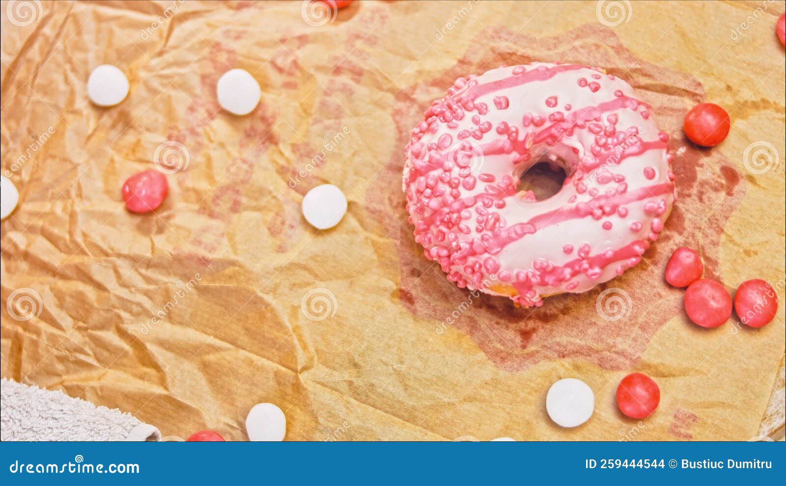 Pink Donuts Decorated with Pink Icing. Donuts are on a Piece of Paper
