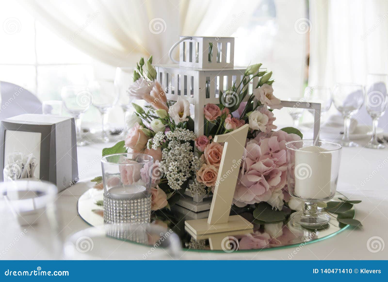 Pink Flowers in a Decorative Cage Stand on the Mirror on the Wedding