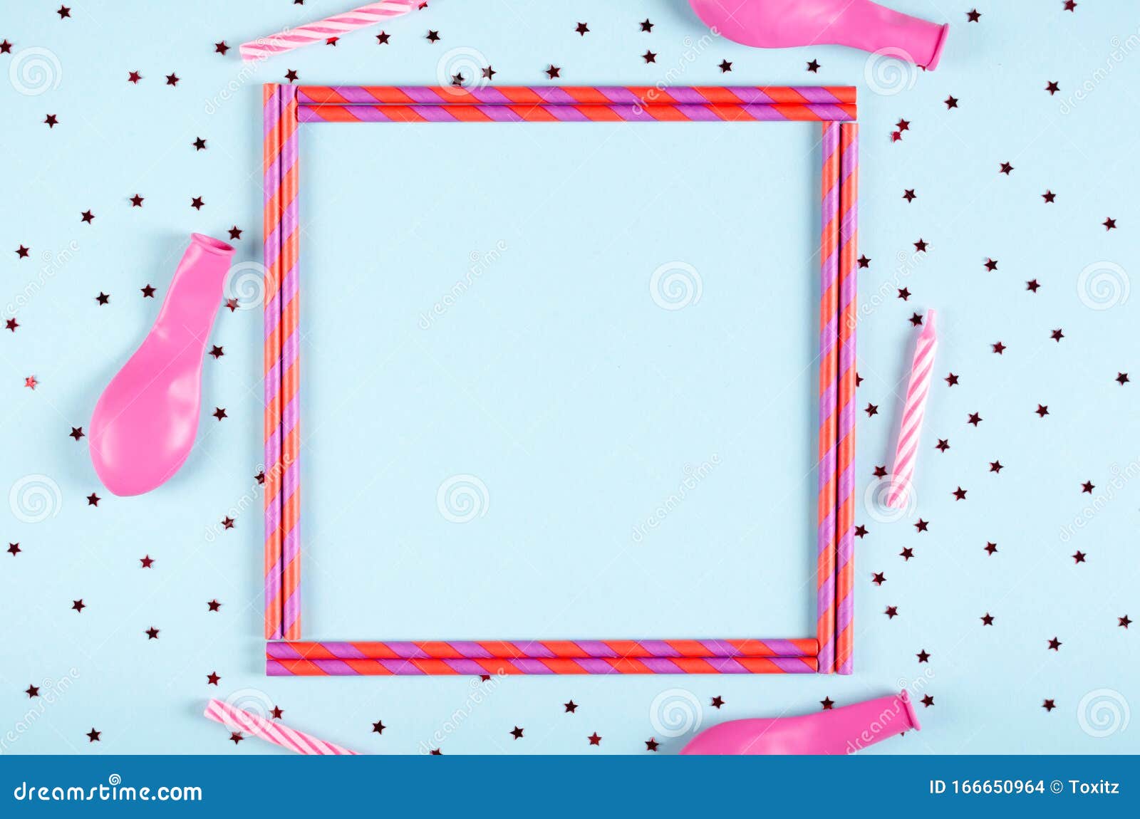 pink frame from straw composition on blue background, party and celebration decoration