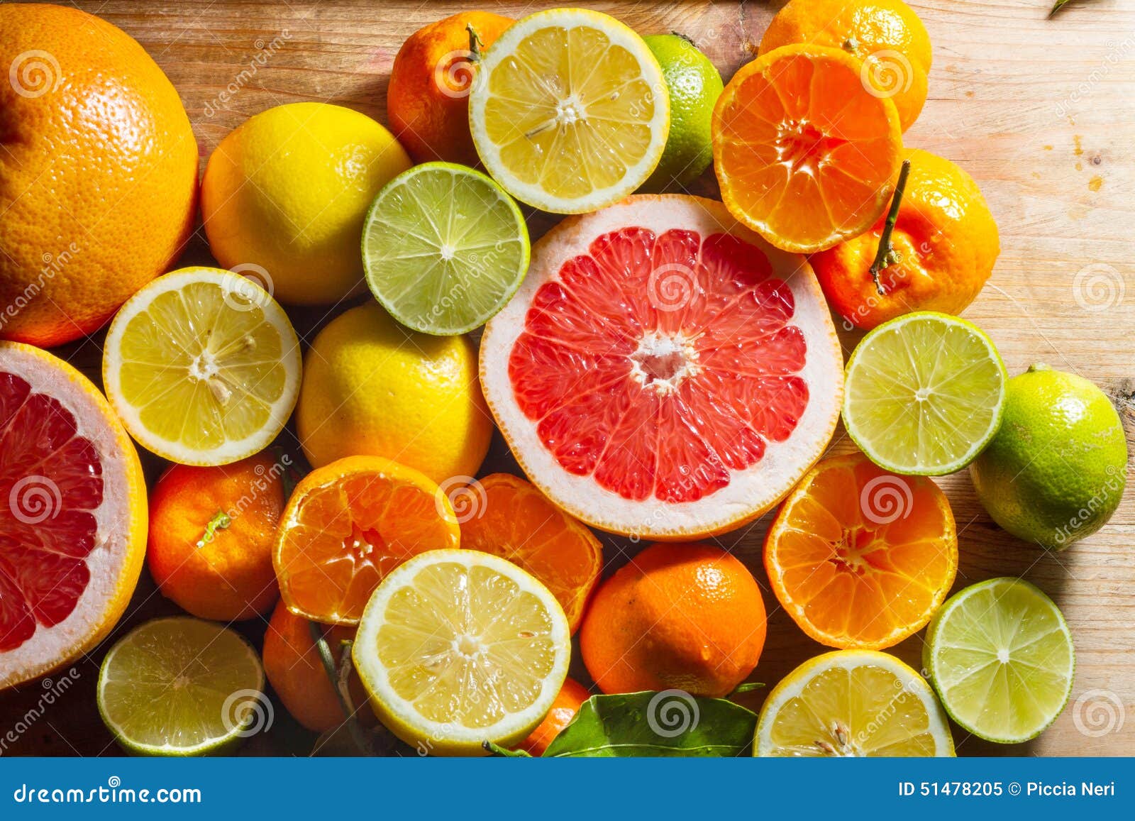 Pink Grapefruit And Other Citrus Fruit Against Wooden Background Stock