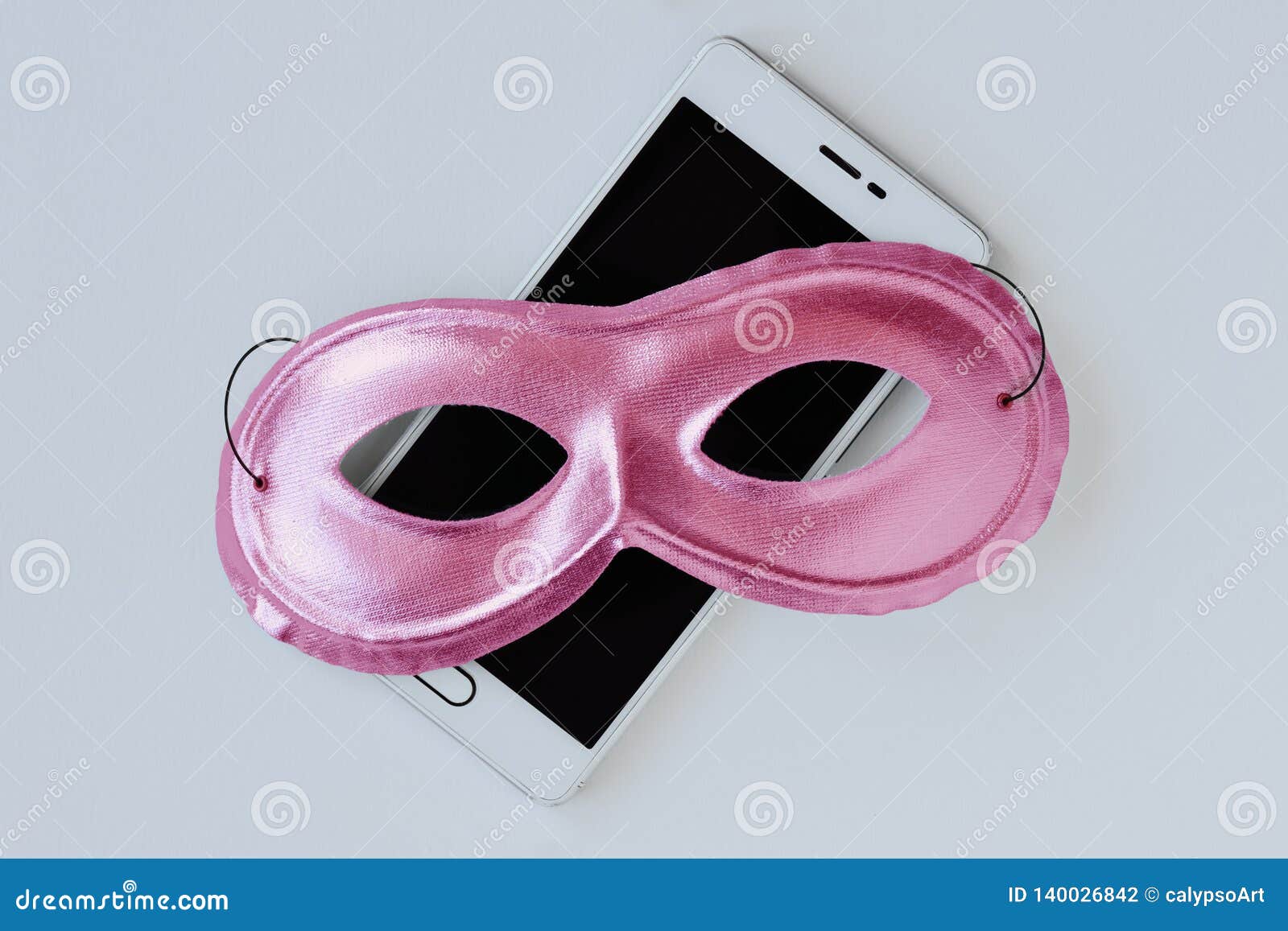 pink mask on mobile phone - concept of privacy, security and anonymity of mobile phone for women